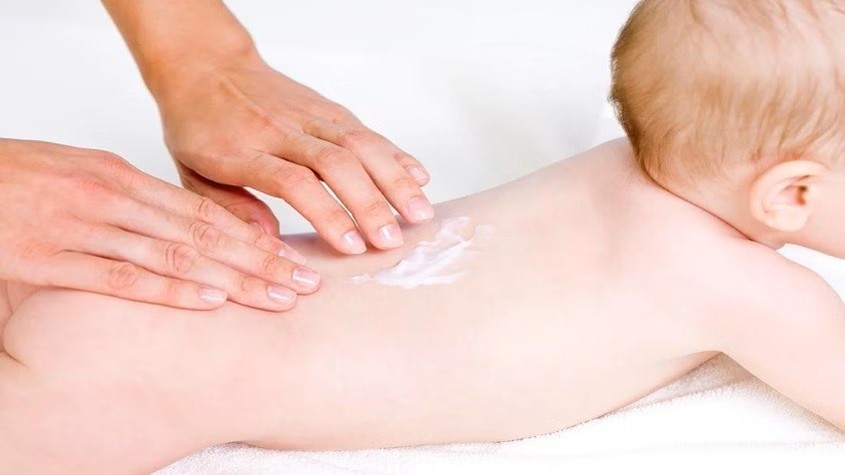A baby being massaged by handsAI-generated content may be incorrect.